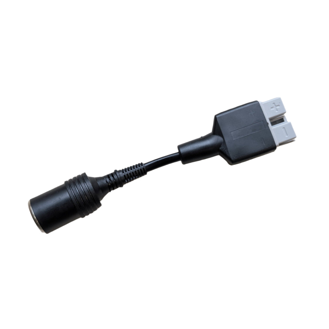 Black adapter cable on a beige surface