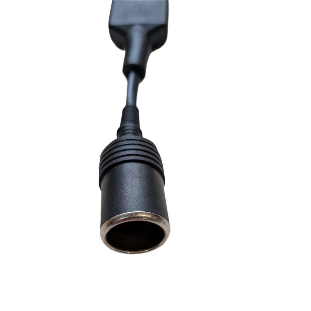 Black electrical plug on a beige surface